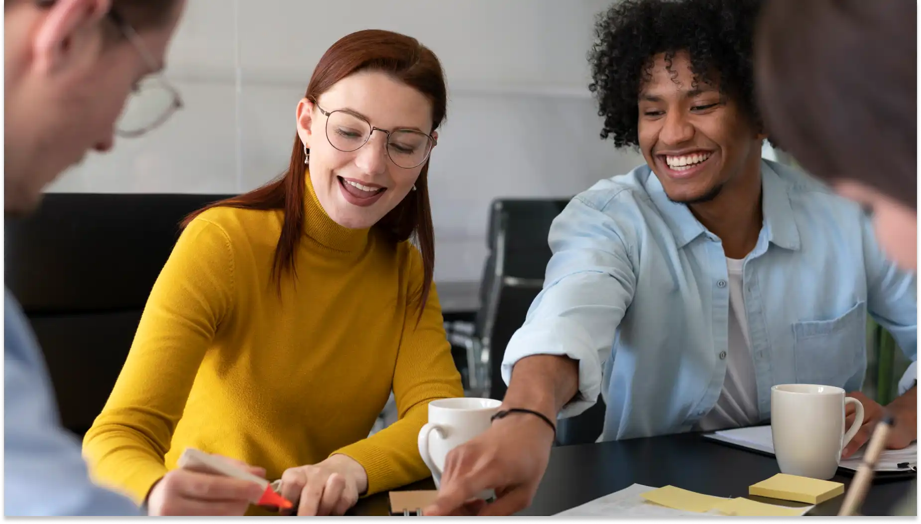 Grupo de jovens aprendizes sorridentes participando de uma reunião de trabalho, interagindo de forma descontraída e colaborativa em um ambiente de escritório moderno.